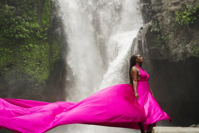 Pink dress next to the waterfall